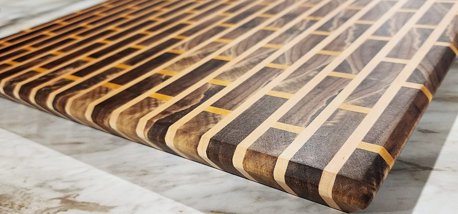 Handcrafted hardwood cutting board with brick pattern