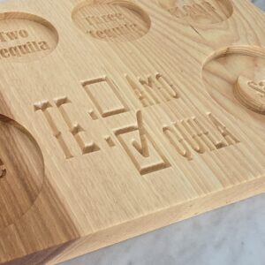 Close view of engraved lettering on handcrafted wooden tequila serving board
