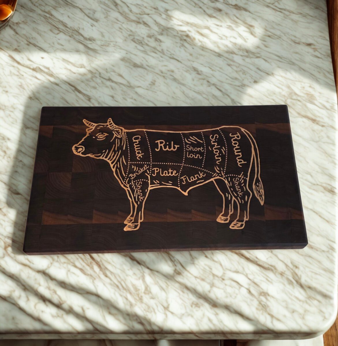 End grain cutting board with butcher-cut cow inlay in walnut and maple, Shield Series relief edition