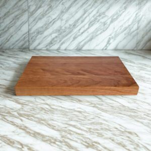 Handcrafted cherry wood cutting board with thick edge grain profile