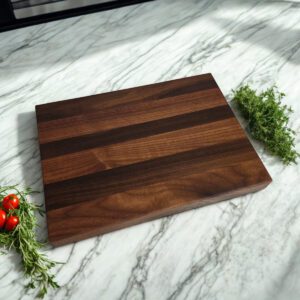 Edge grain walnut cutting board with square profile on kitchen counter
